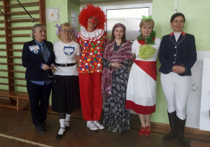 Sześciu nauczycieli stoi obok siebie w kolorowych przebraniach.