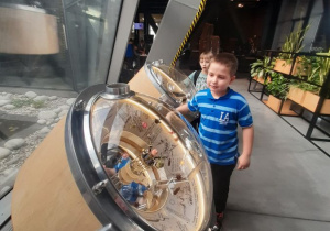 Dwóch chłopców bada tajemnicze busole w Centrum Nauki Kopernik.