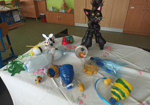 Zabawki ekologiczne wykonane z butelek typu PET przez uczniów klasy 4a i 5a, między innymi kot, żółw, świnka, helikopter